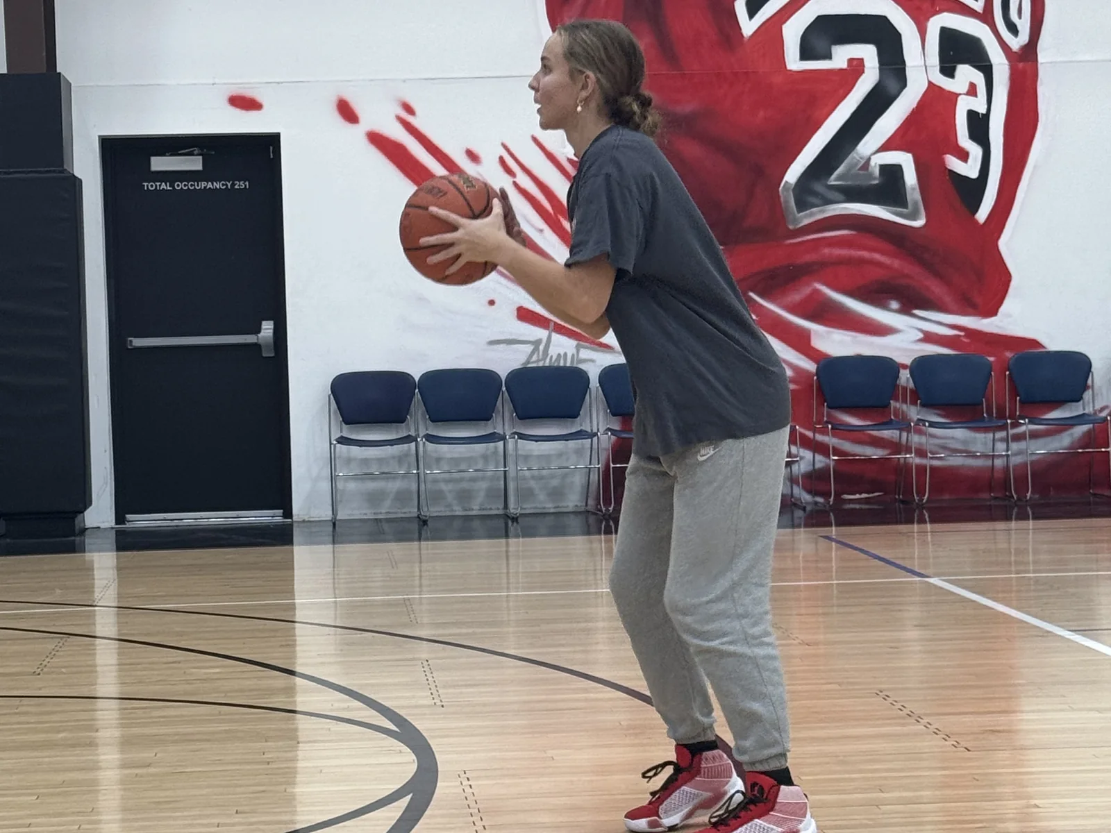 A Training Zone player working on her shooting form in the gym at the Herriman facility