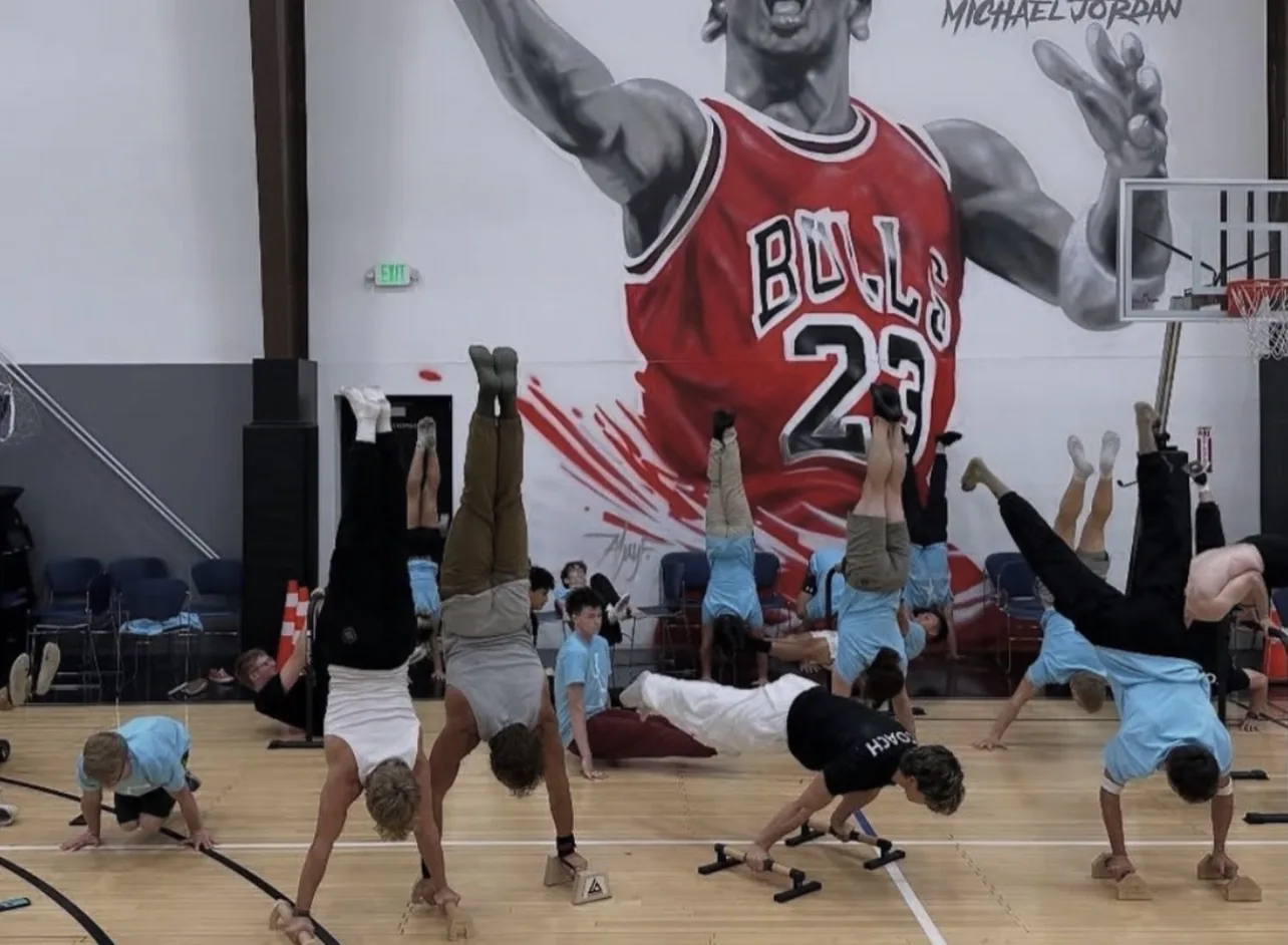 A calisthenics group running a training camp on the court at Training Zone in Herriman, Utah