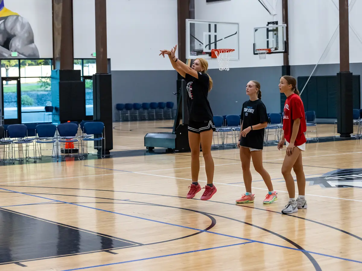 Cailin rising into a jump shot at Training Zone while two teammates watch