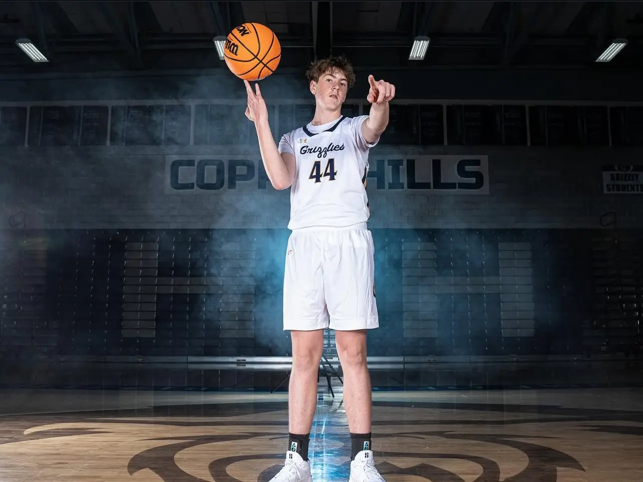 Connor in his Copper Hills uniform, spinning a basketball on his finger